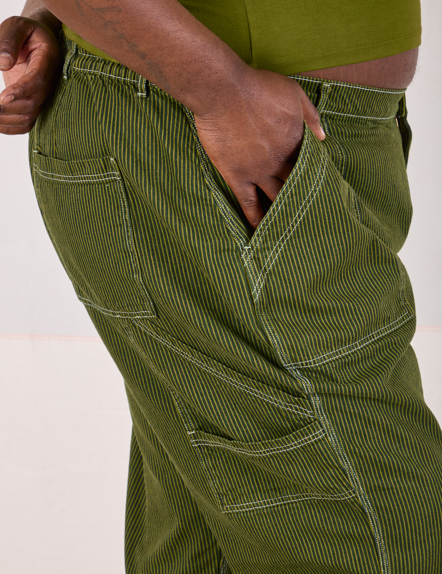 Railroad Carpenter Jeans in Summer Olive side close up on Elijah