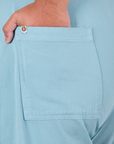 Close up of Miguel's hand in the back pocket of Work Pants in Baby Blue