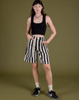Alex is 5’8” and wearing XXS Longline Work Shorts in Natural paired with black Cropped Tank