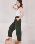 Side view of Heavyweight Trousers in Swamp Green and Cropped Tank Top in vintage tee off-white on Hana