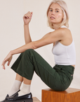 Madeline is wearing Work Pants in Swamp Green and Cropped Tank Top in vintage tee off-white