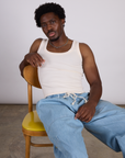 The Tank Top in Vintage Tee Off-White and light wash denim drop pocket pants. on Isaac