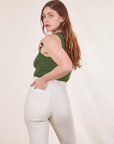 Back view of Tank Top in Dark Emerald Green and vintage tee off-white Western Pants worn by Allison