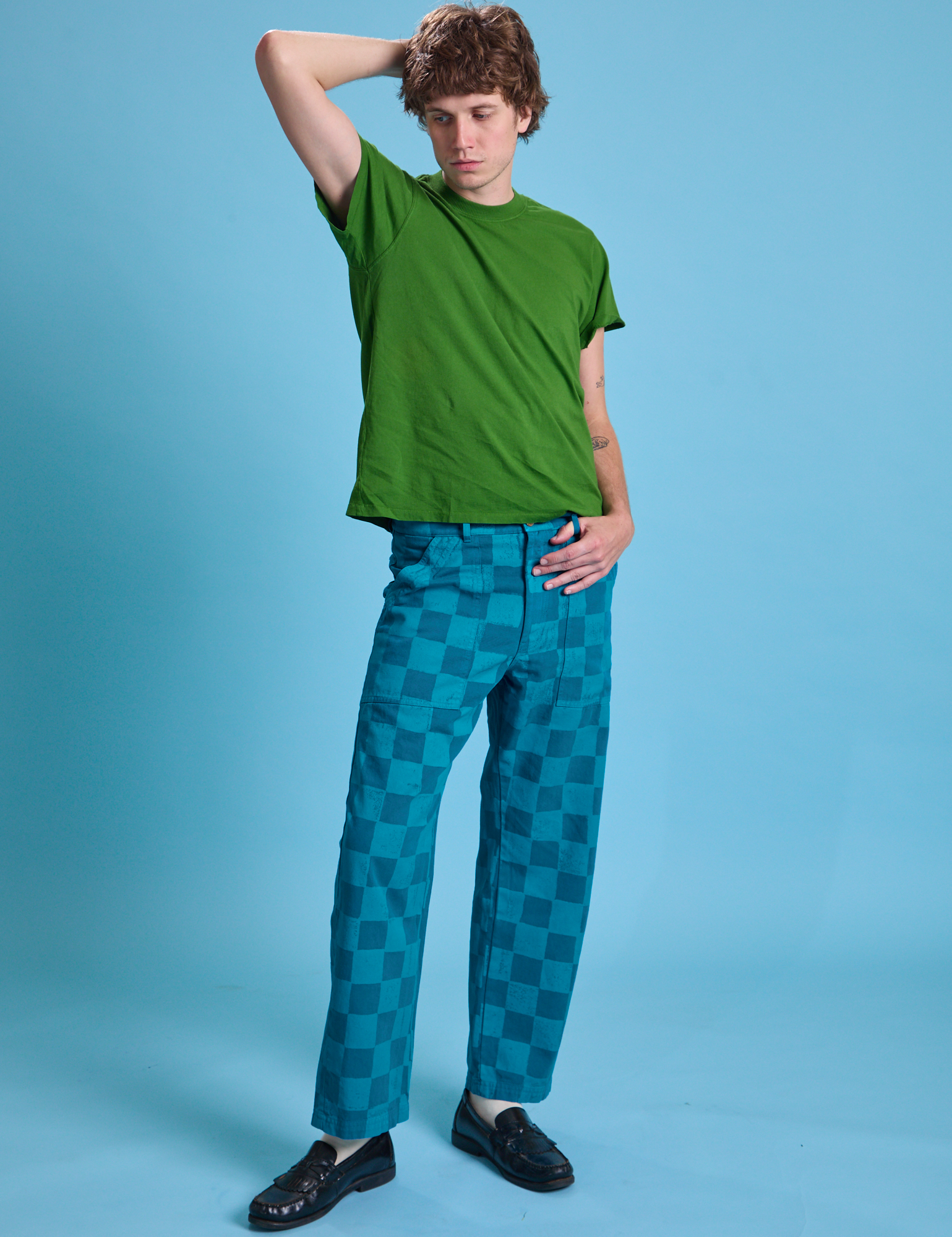 Quinn is wearing Checkerboard Work Pants in Blues and lawn green Organic Vintage Tee
