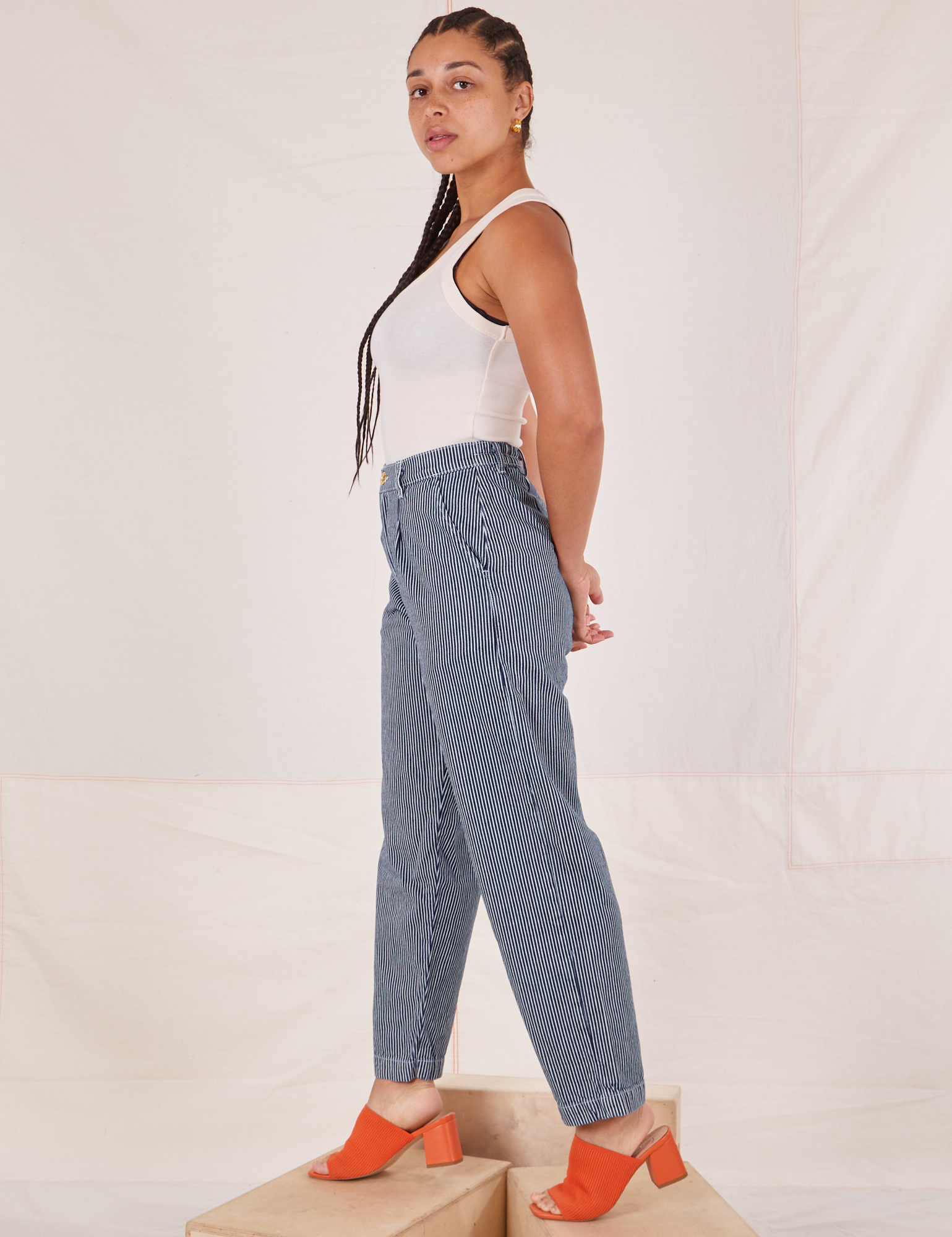 Side view of Denim Trouser Jeans in Railroad Stripe and Tank Top in vintage tee off-white worn by Gabi