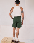 Back view of Trouser Shorts in Swamp Green and Tank Top in vintage tee off-white on Jesse