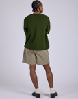 Back view of Pleated Trouser Shorts in Khaki Grey and evergreen Long Sleeve Burly Tee