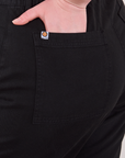 Close up of Lish's hand in the back pocket of Western Pants in Basic Black