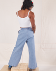 Back view of Indigo Wide Leg Trousers in Light Wash and vintage off-white Cami on Jerrod