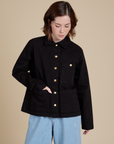 Hana is wearing a buttoned up Work Jacket in Basic Black