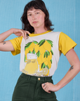 Alex is wearing Anniversary Tee in Lemon tucked in swamp green Work Pants