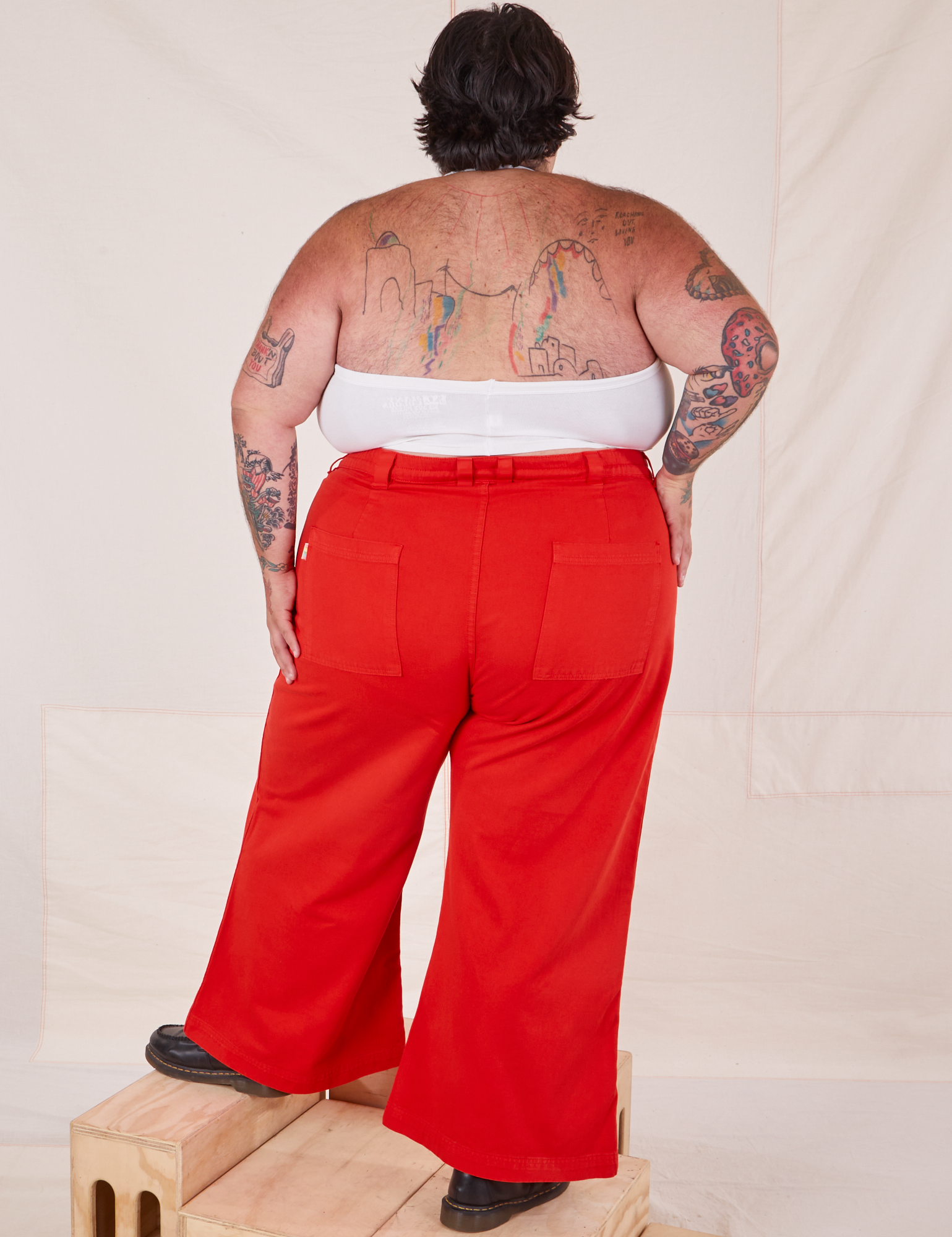 Back view of Bell Bottoms in Mustang Red and Halter Top in vintage tee off-white on Sam