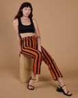 Black Stripe Work Pants in Construction Orange and black mini crop tank on Alex