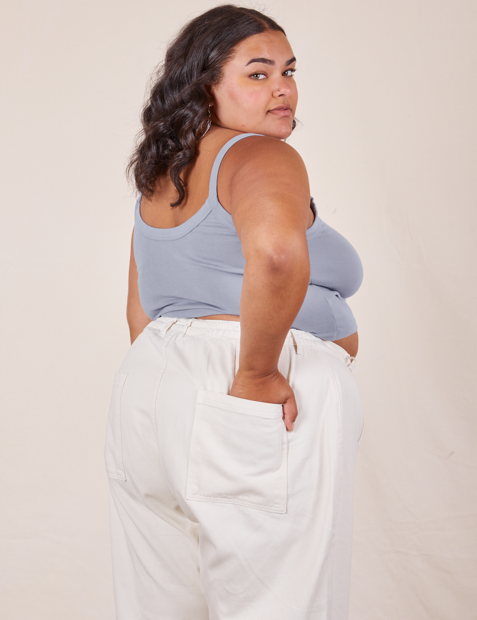 Angled back view of Cropped Cami in Periwinkle and vintage tee off-white Western Pants worn by Alicia
