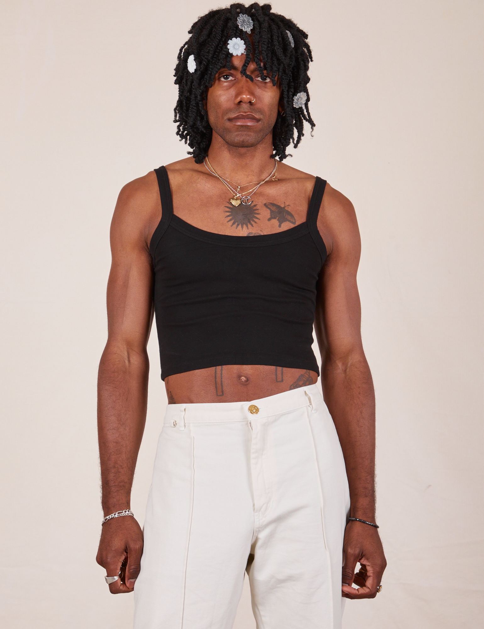 Jerrod is wearing S Cropped Cami in Basic Black paired with vintage tee off-white Western Pants