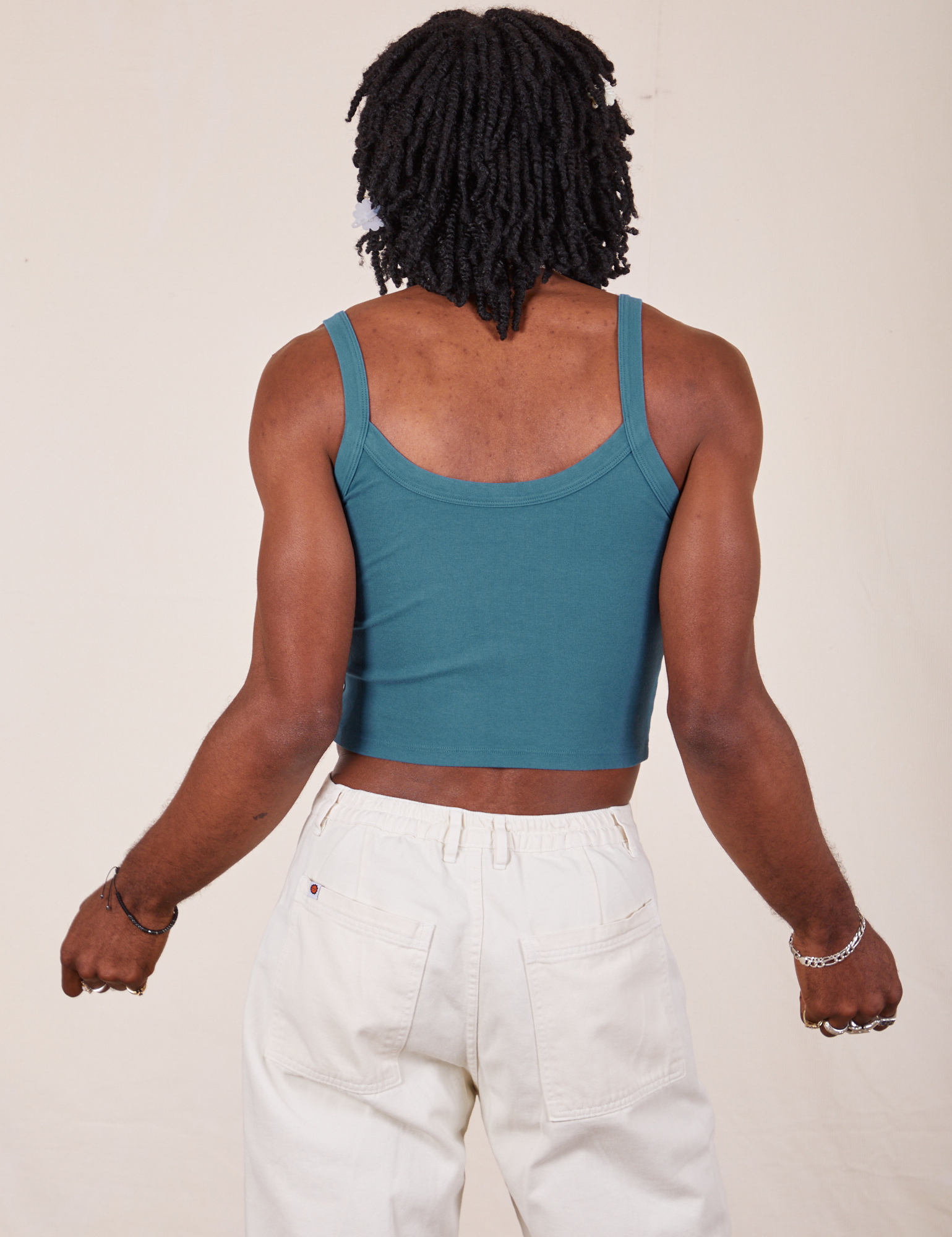 Back view of Cropped Cami in Marine Blue and vintage tee off-white Western Pants worn by Jerrod