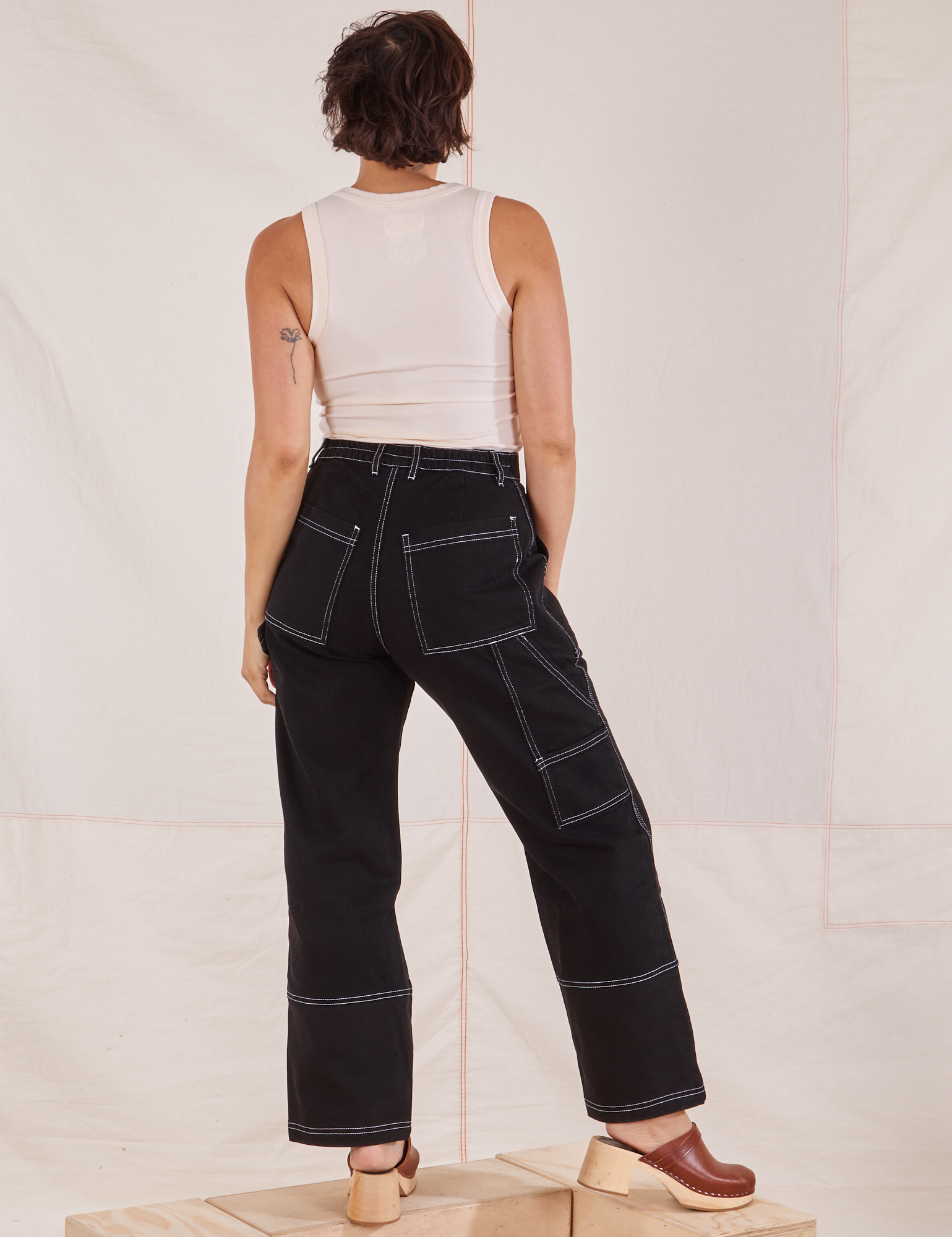 Back view of Carpenter Jeans in Black and Tank Top in vintage tee off-white worn by Tiara
