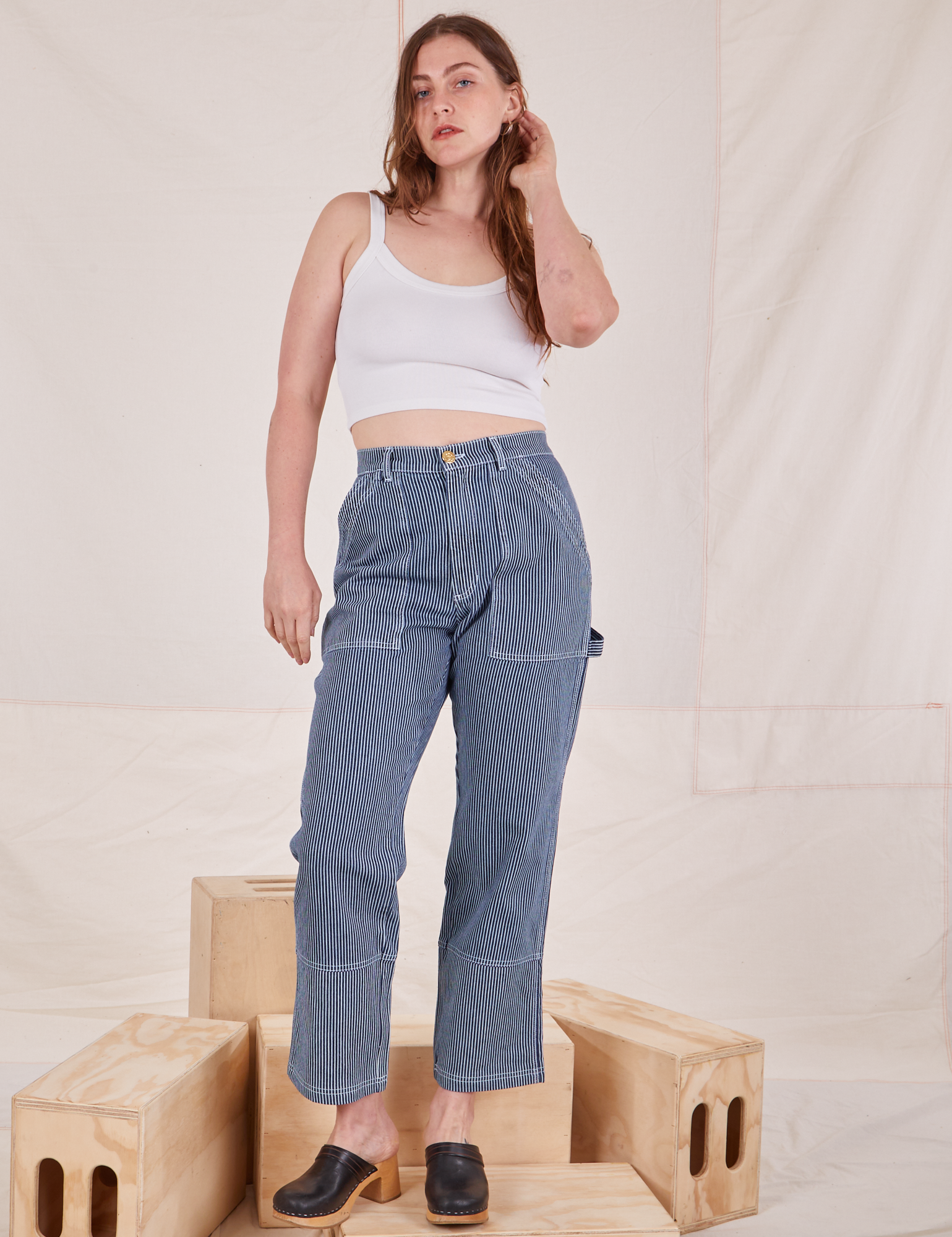 Allison is wearing Carpenter Jeans in Railroad Stripes and Cropped Cami in vintage tee off-white