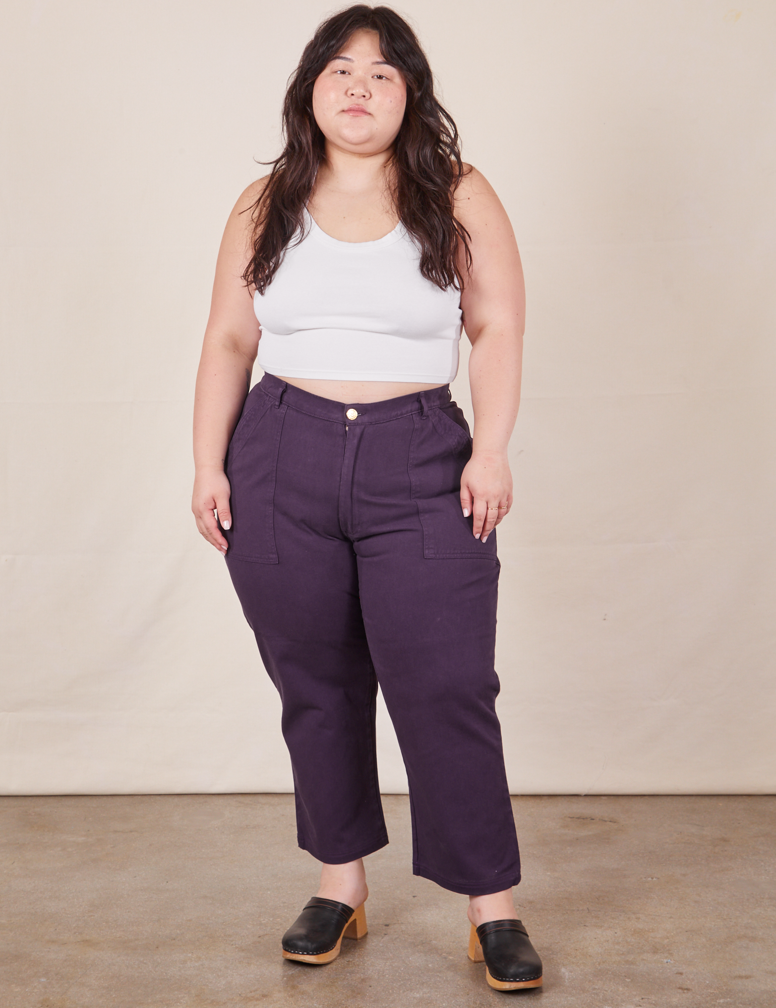 Ashley is 5&#39;7&quot; and wearing 1XL Petite Work Pants in Nebula Purple and Halter Top in vintage tee off-white