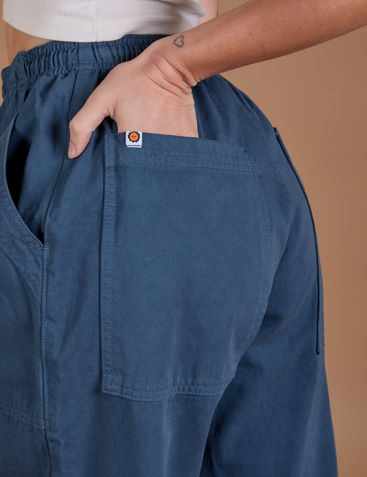 Close up of Alex's hand in the back pocket of Drop Pocket Cargo Pants in French Blue