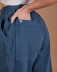 Close up of Alex's hand in the back pocket of Drop Pocket Cargo Pants in French Blue
