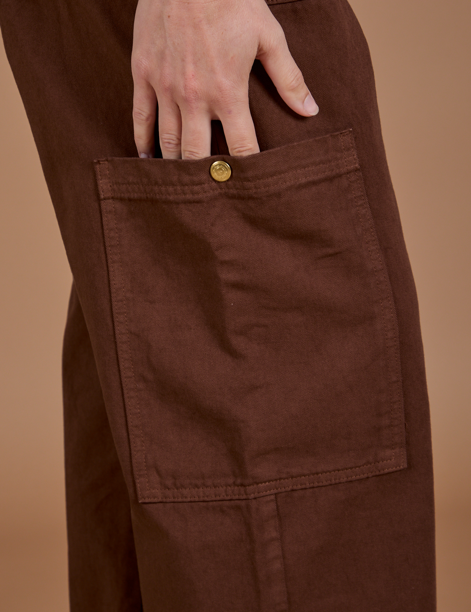 Close up of Drop Pocket Cargo Pants in Fudgesicle Brown side pant leg pocket on Alex