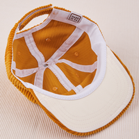 Dugout Corduroy Hat in Spicy Mustard flipped over. White satin under-bill.