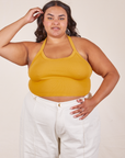 Alicia is 5'9" and wearing XL Halter Top in Mustard Yellow paired with vintage off-white Western Pants