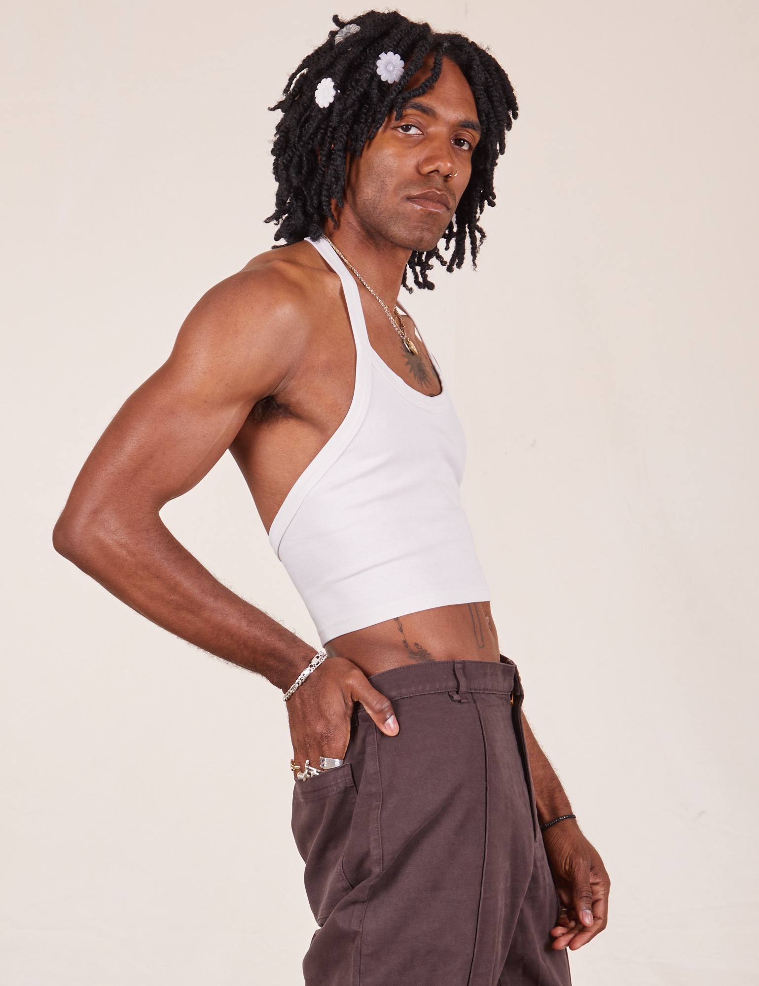 Side view of Halter Top in Vintage Tee Off-White and espresso brown Western Pants worn by Jerrod