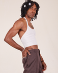 Side view of Halter Top in Vintage Tee Off-White and espresso brown Western Pants worn by Jerrod