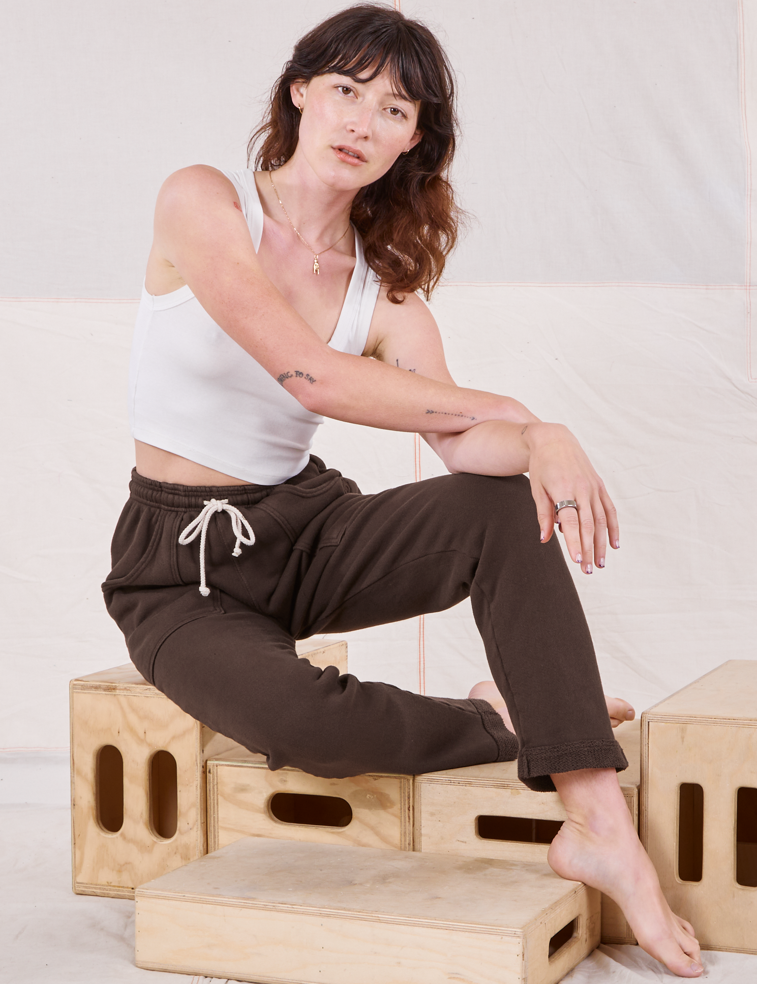 Alex is wearing Rolled Cuff Sweat Pants in Espresso Brown and Cropped Tank in vintage tee off-white