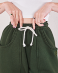 Rolled Cuff Sweat Pants in Swamp Green front close up on Alex