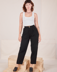Alex is 5'8" and wearing XXS Heavyweight Trousers in Basic Black paired with Cropped Tank Top in vintage tee off-white