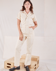Alex is wearing Heritage Short Sleeve Jumpsuit in Natural