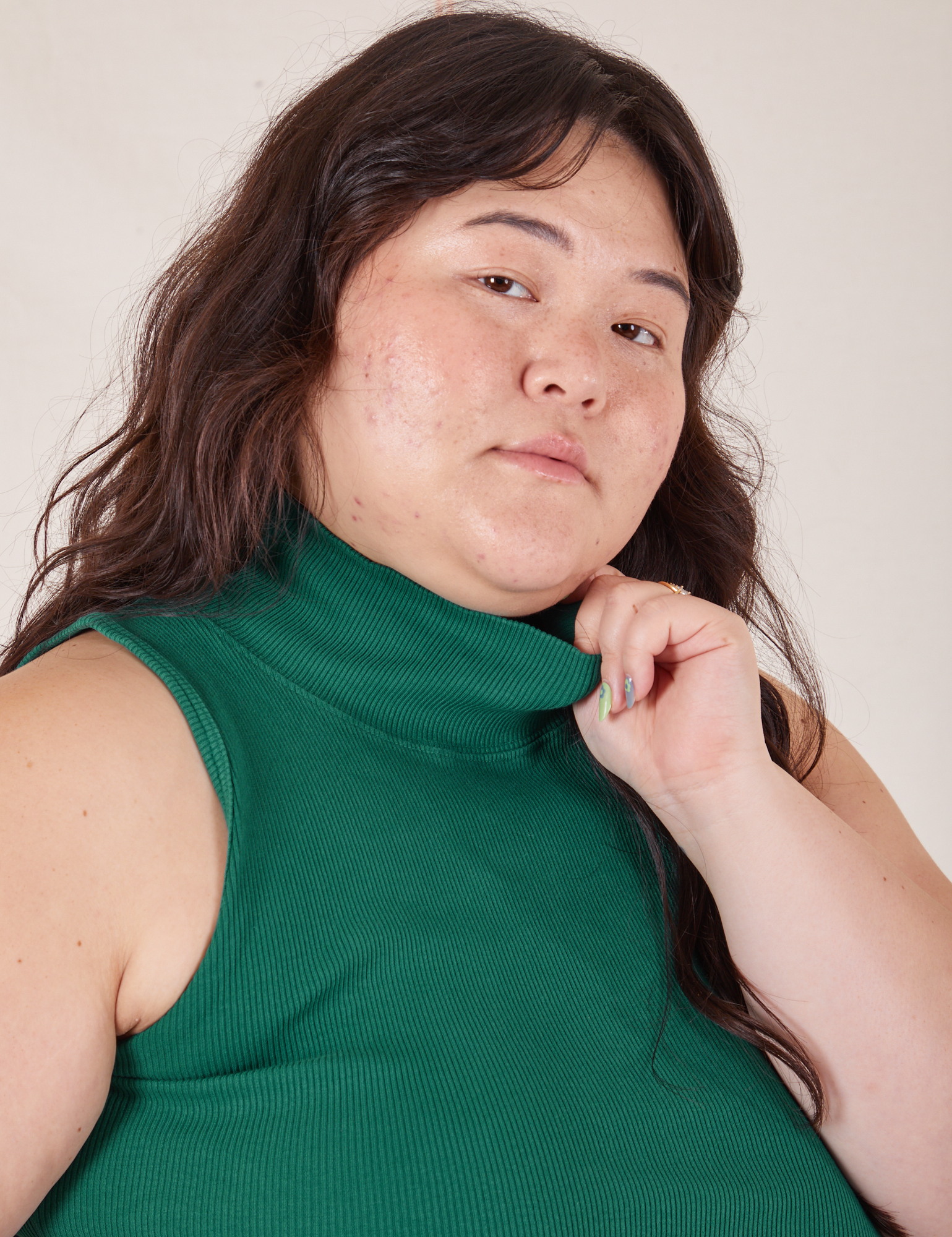 Close up of Sleeveless Essential Turtleneck in Hunter Green on Ashley