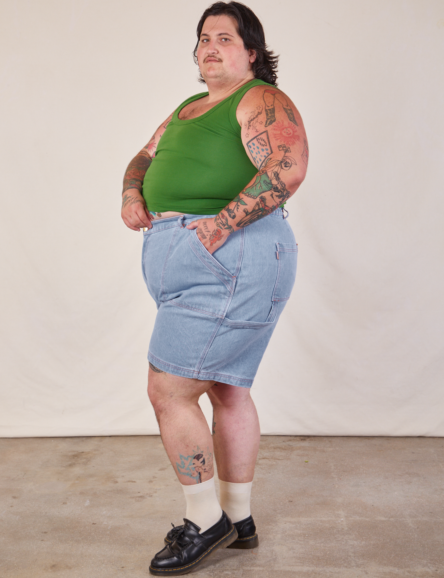 Side view of Carpenter Shorts in Light Wash and lawn green Cropped Tank on Sam