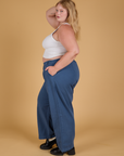 Side view of Baggy Mid-Rise Trousers in French Blue and vintage tee white Cropped Tank on Juliet