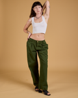 Alex is 5'8" and wearing XXS Baggy Mid-Rise Trousers in Evergreen paired with a vintage tee white Cropped Tank