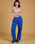 Alex is wearing Baggy Mid-Rise Trousers in Royal Blue and vintage tee white Cropped Tank
