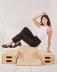Alex is wearing Organic Work Pants in Basic Black and Racerback Tank in vintage tee off-white