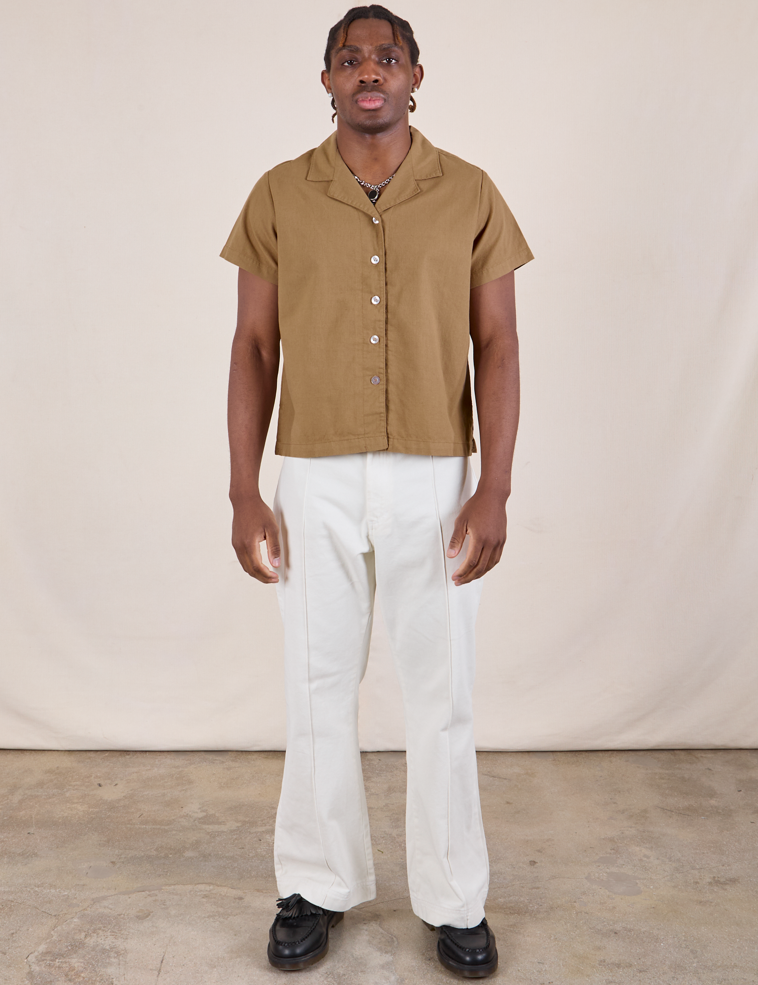 Isaac is wearing Pantry Button-Up in Desert Brown and vintage tee off-white Western Pants