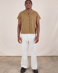 Isaac is wearing Pantry Button-Up in Desert Brown and vintage tee off-white Western Pants