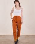 Hana is 5'3" and wearing XXS Petite Pencil Pants in Burnt Terracotta paired with Cropped Cami in vintage tee off-white