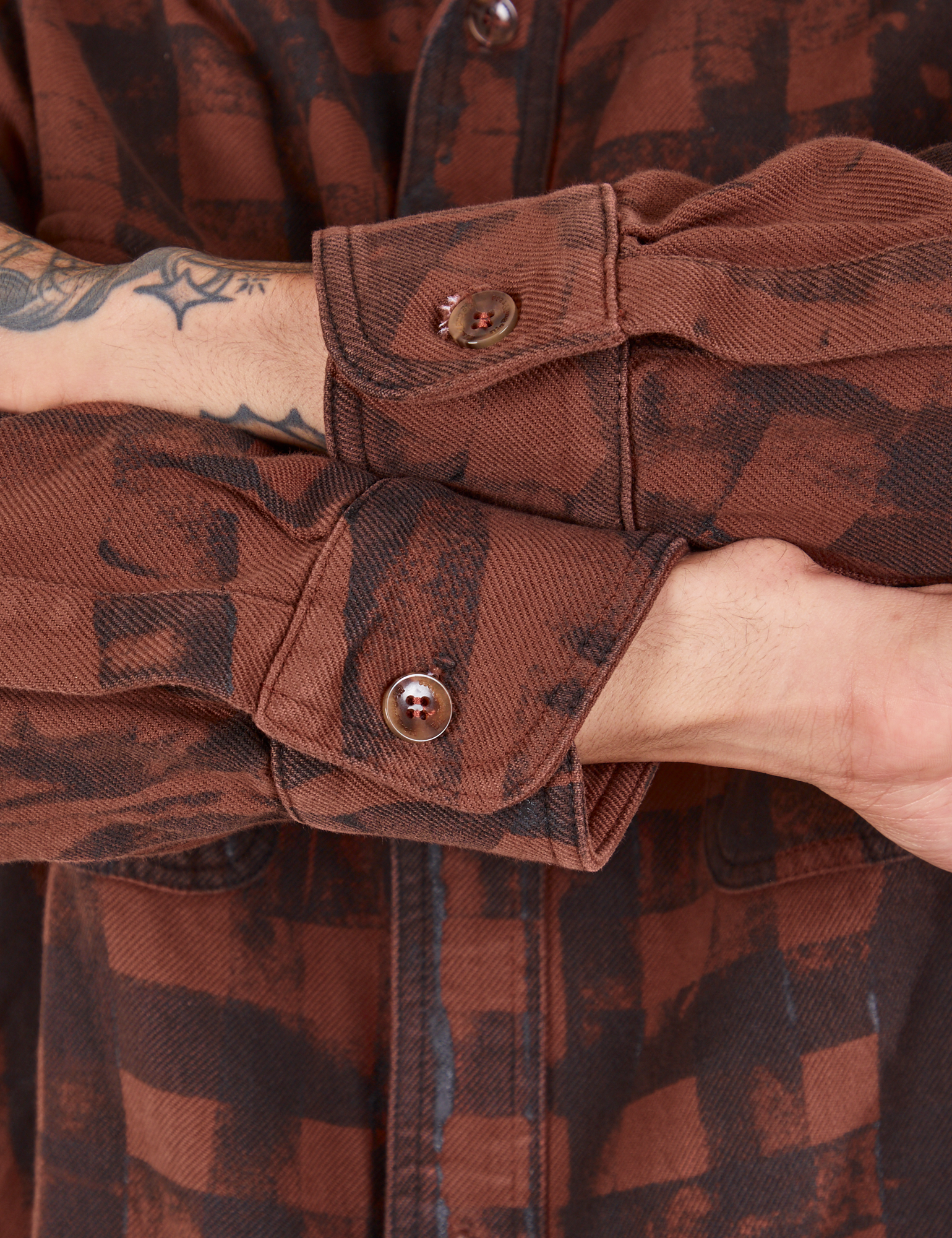 Plaid Flannel Overshirt in Fudgesicle Brown sleeve close up on Jesse