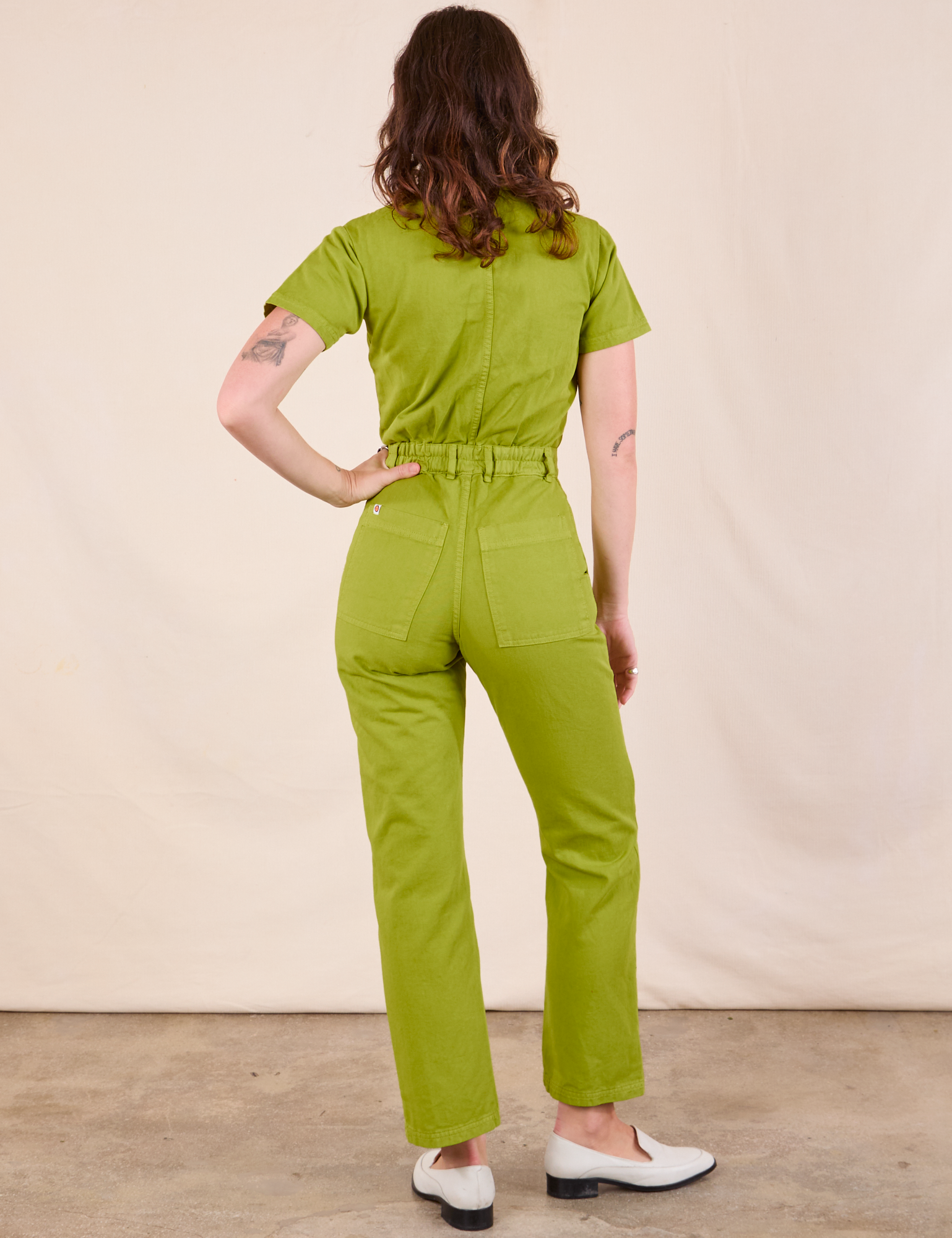 Short Sleeve Jumpsuit in Gross Green back view on Alex