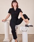 Alex is wearing Short Sleeve Jumpsuit in Basic Black