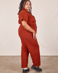 Side view of Short Sleeve Jumpsuit in Paprika worn by Alicia