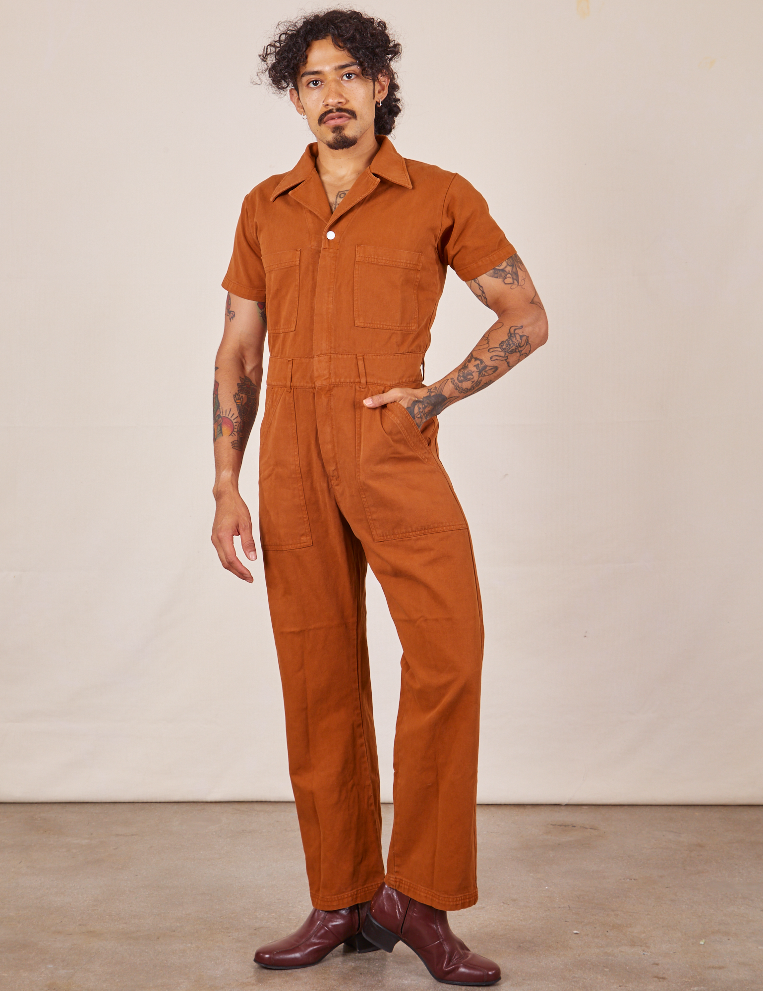 Jesse is wearing Short Sleeve Jumpsuit in Burnt Terracotta