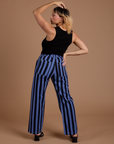 Back view of Black Stripe Work Pants in Cornflower Blue and black Cropped Tank on Tiara