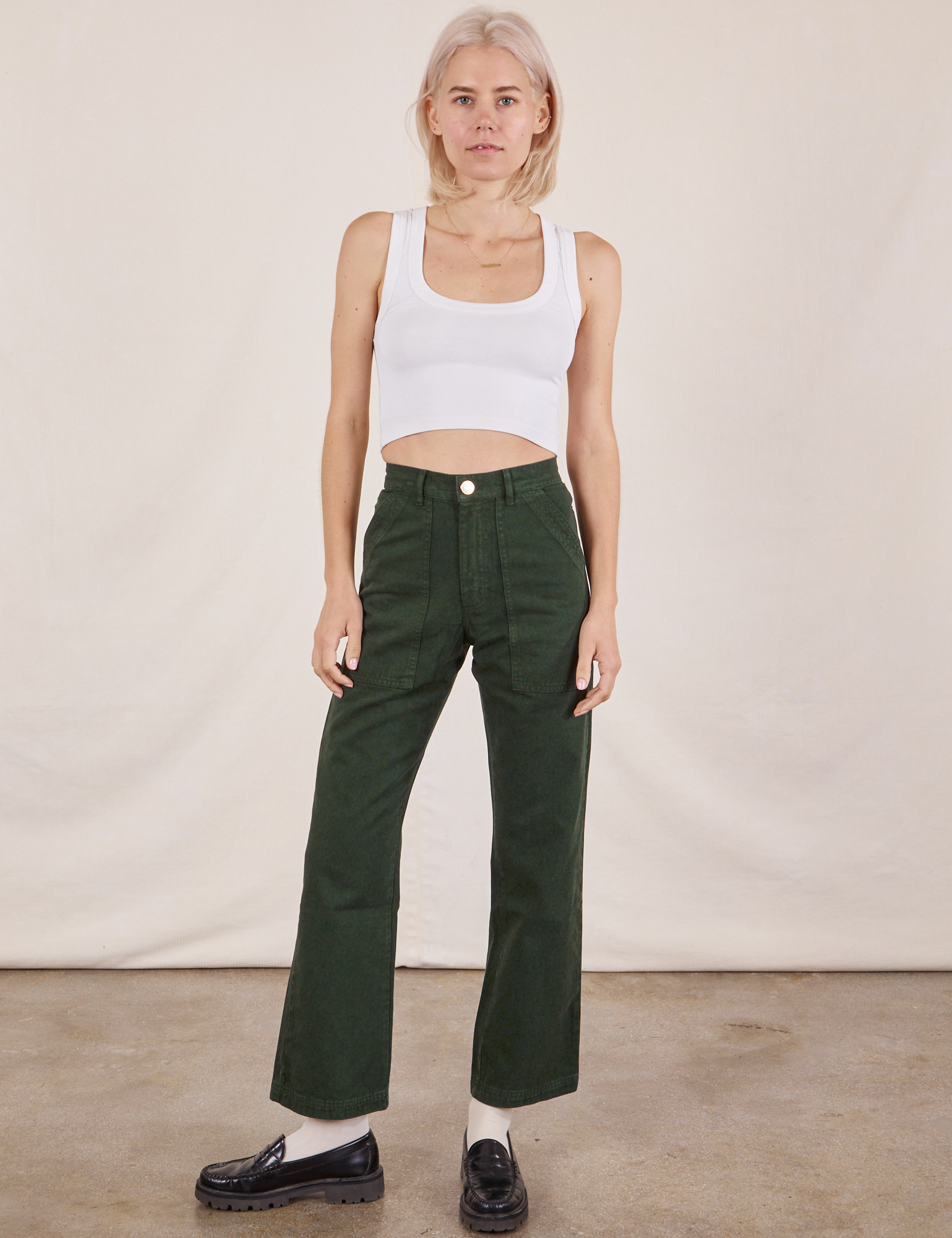 Madeline is 5&#39;9&quot; and wearing XXS Work Pants in Swamp Green paired with vintage tee off-white Cropped Tank